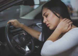 Medical Payments (MedPay) - Young Woman Rubbing Her Neck and Feeling Sore After Whiplash in a Car Crash